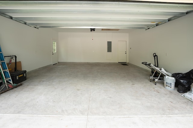 garage with a garage door opener and electric panel