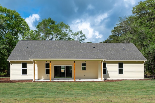 rear view of property featuring a yard, roof with shingles, ceiling fan, and a patio area