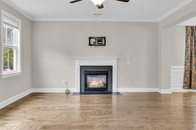 unfurnished living room featuring ornamental molding, ceiling fan, and light hardwood / wood-style flooring