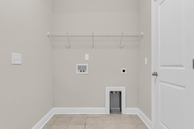 washroom with washer hookup, hookup for an electric dryer, and light tile patterned floors