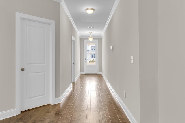 doorway to outside featuring ornamental molding and hardwood / wood-style floors