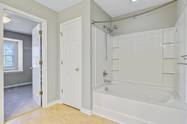 bathroom with baseboards, bathing tub / shower combination, and tile patterned floors