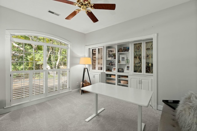 office featuring ceiling fan and light carpet