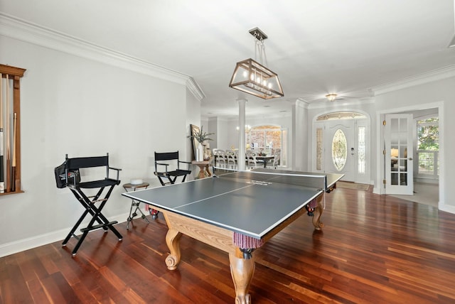 game room with ornamental molding and dark wood-type flooring