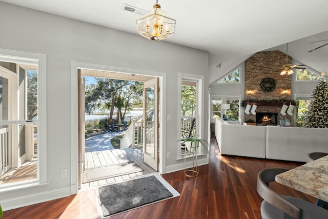 entryway with plenty of natural light, dark hardwood / wood-style floors, and vaulted ceiling