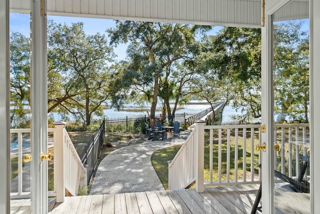 wooden terrace featuring a water view