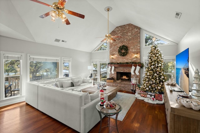 living room featuring plenty of natural light, dark hardwood / wood-style flooring, a fireplace, and high vaulted ceiling