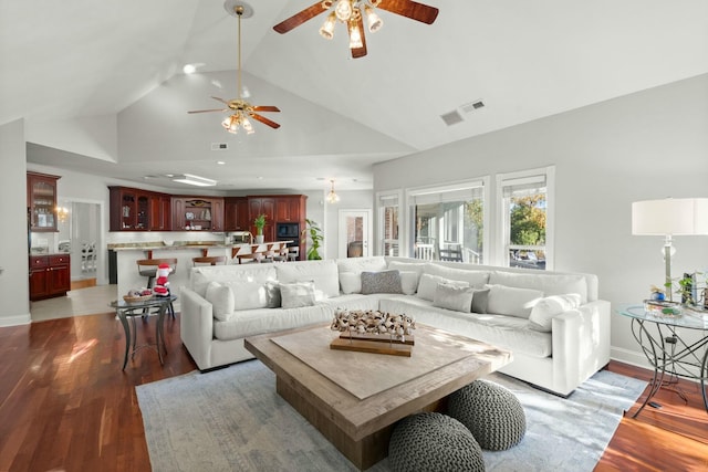 living room featuring ceiling fan, hardwood / wood-style floors, and high vaulted ceiling