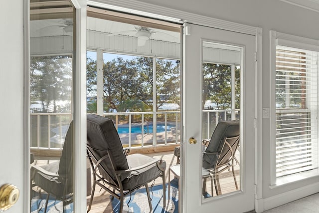 doorway to outside featuring plenty of natural light and ceiling fan