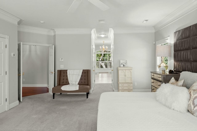 carpeted bedroom with ceiling fan with notable chandelier and ornamental molding