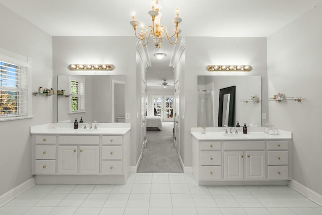 bathroom featuring tile patterned flooring, vanity, and ceiling fan with notable chandelier