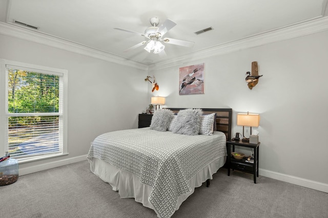 carpeted bedroom with ceiling fan and crown molding