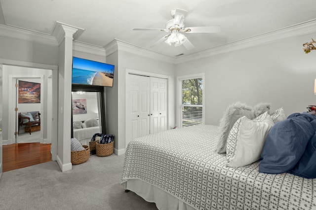 bedroom with ceiling fan, a closet, light colored carpet, and crown molding