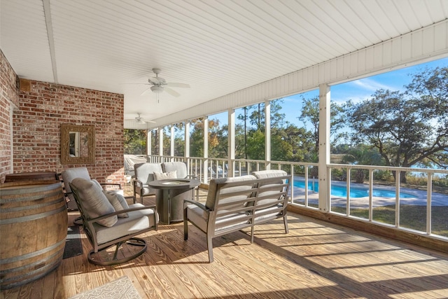 sunroom / solarium featuring ceiling fan and a healthy amount of sunlight