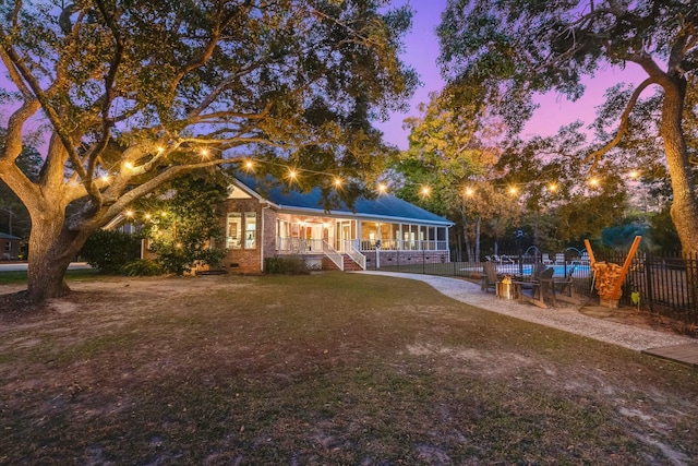 yard at dusk with a sunroom