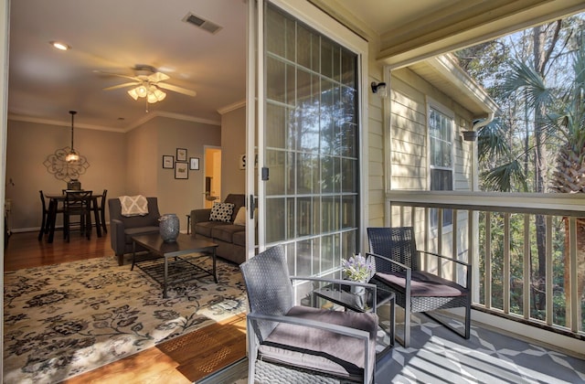 sunroom featuring visible vents and a ceiling fan