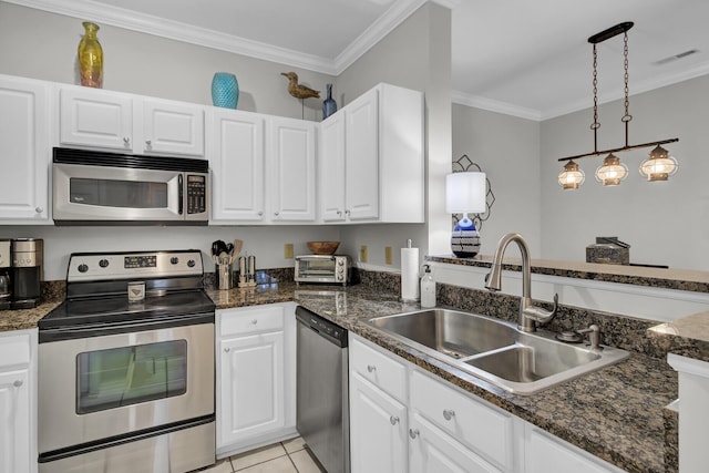 kitchen featuring stainless steel appliances, visible vents, ornamental molding, white cabinets, and a sink