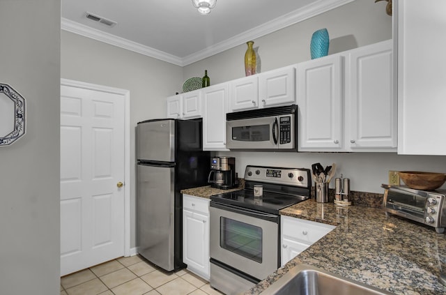 kitchen with crown molding, light tile patterned floors, stainless steel appliances, visible vents, and white cabinetry