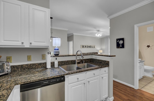 kitchen with a sink, white cabinetry, ornamental molding, and stainless steel dishwasher