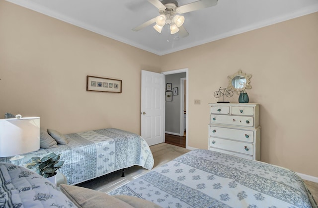 bedroom with baseboards, a ceiling fan, and wood finished floors