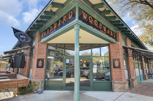 entrance to property featuring brick siding