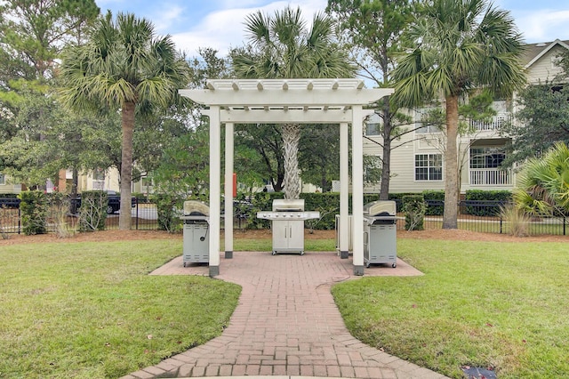 view of home's community featuring fence, a pergola, and a lawn