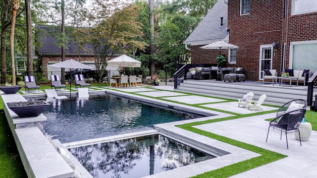 view of pool featuring a fenced in pool, fence, an outdoor hangout area, an in ground hot tub, and a patio