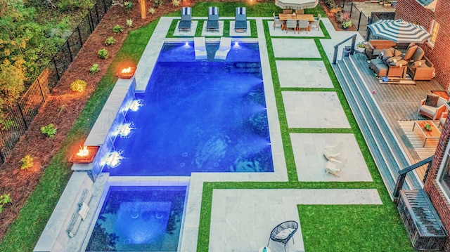 pool with a patio and a fenced backyard