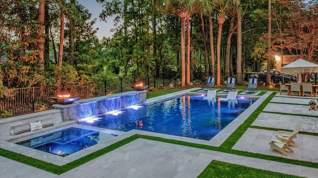 view of pool featuring a fenced in pool, an in ground hot tub, a fenced backyard, and a patio area