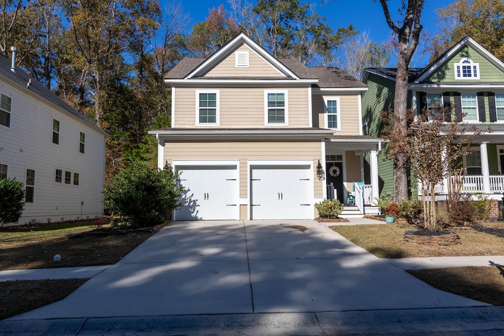 front facade with covered porch and a garage