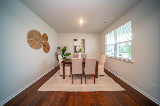 dining space with wood-type flooring