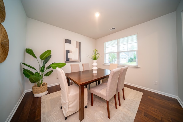 dining space with wood-type flooring