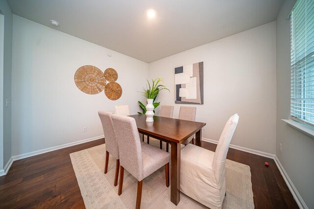 dining space with dark hardwood / wood-style floors