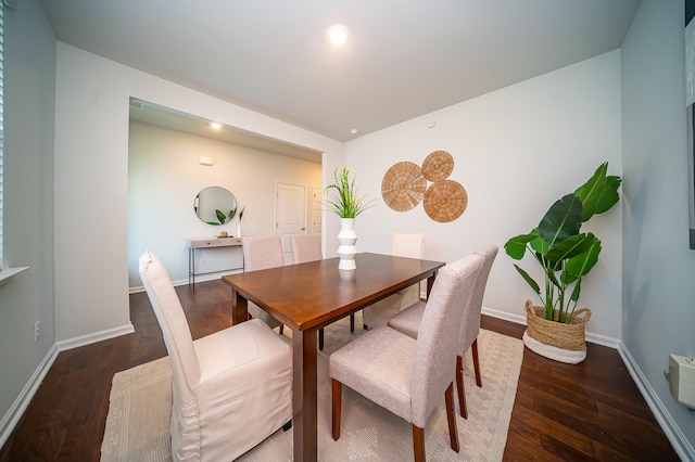 dining area with dark hardwood / wood-style flooring