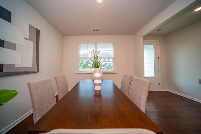 unfurnished dining area with dark wood-type flooring