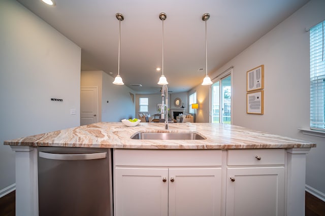 kitchen with sink, stainless steel dishwasher, a wealth of natural light, and white cabinets