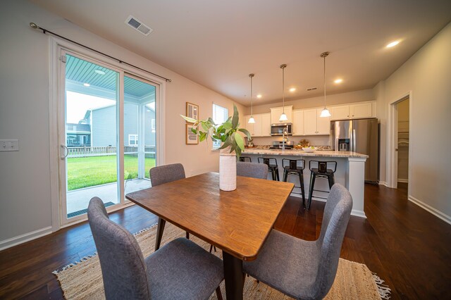 dining area with dark hardwood / wood-style floors