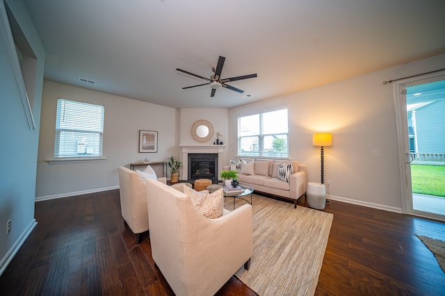 living room featuring dark hardwood / wood-style flooring, a wealth of natural light, and ceiling fan