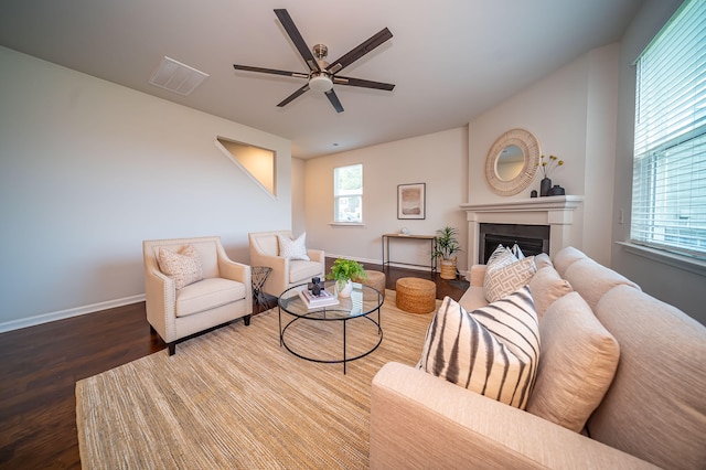 living room featuring hardwood / wood-style floors and ceiling fan