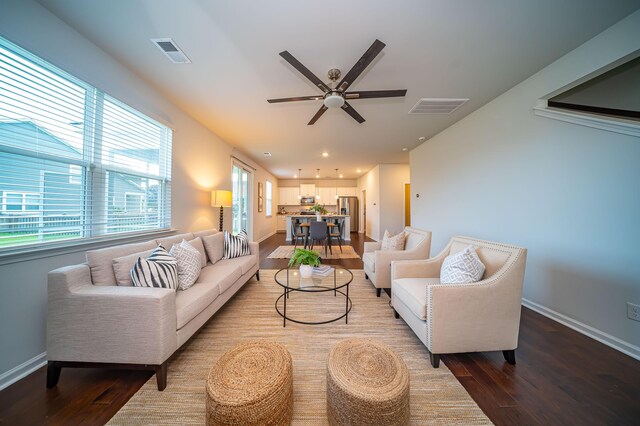 living room featuring light hardwood / wood-style flooring and ceiling fan