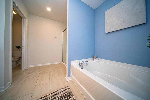 bathroom featuring tile patterned floors, plus walk in shower, and toilet