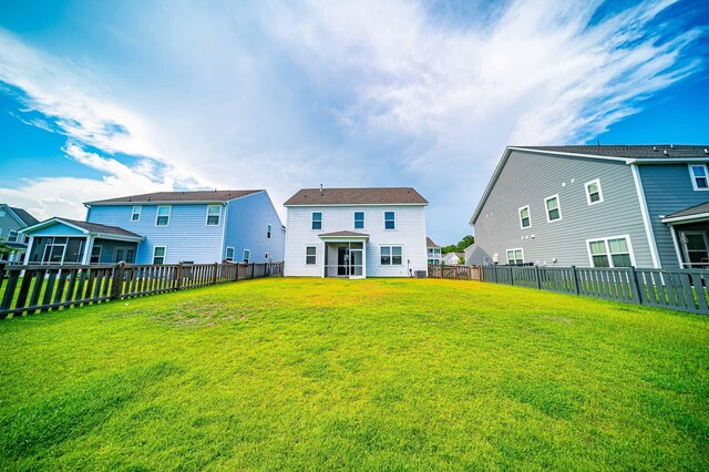 back of property featuring a lawn