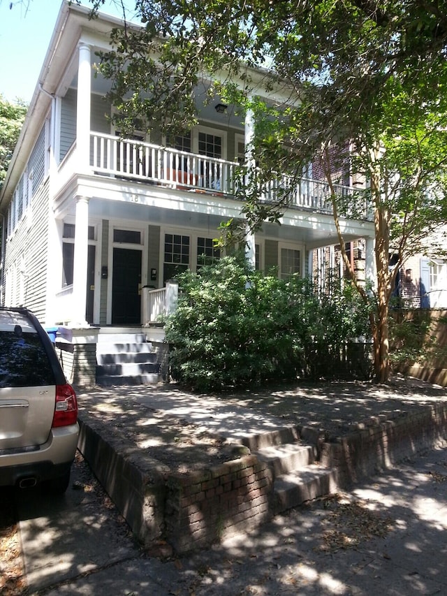 view of front facade featuring a balcony and a porch