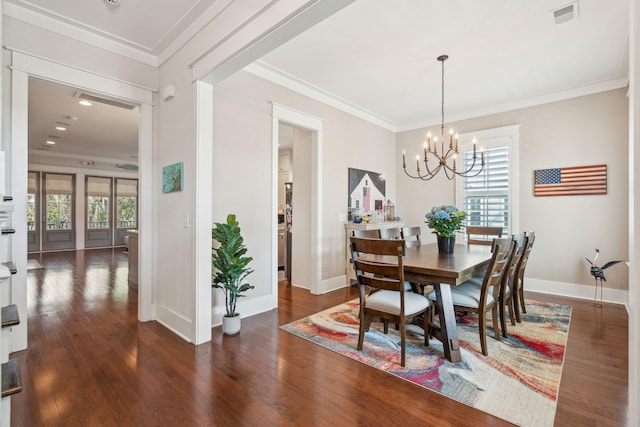 dining room with baseboards, visible vents, ornamental molding, dark wood-style flooring, and a notable chandelier