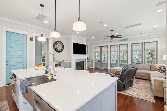 kitchen with dark wood-style floors, visible vents, open floor plan, and dishwasher