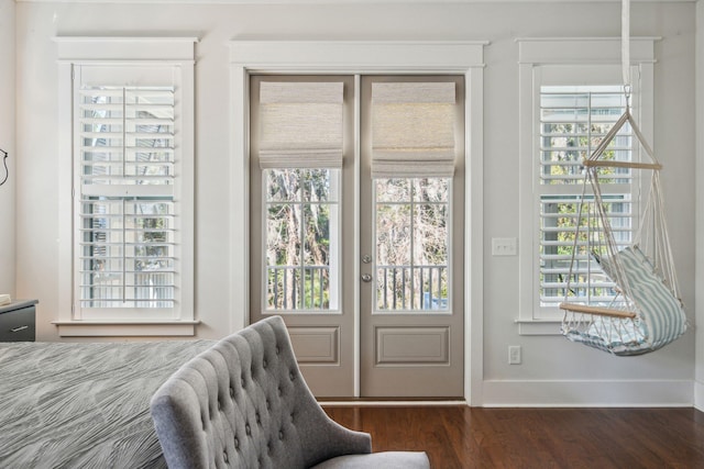 entryway featuring baseboards and wood finished floors