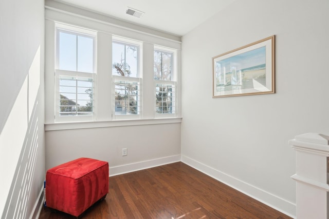 unfurnished room with a wealth of natural light, visible vents, and baseboards