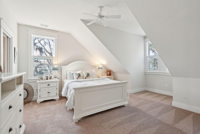 bedroom with vaulted ceiling, baseboards, visible vents, and light colored carpet