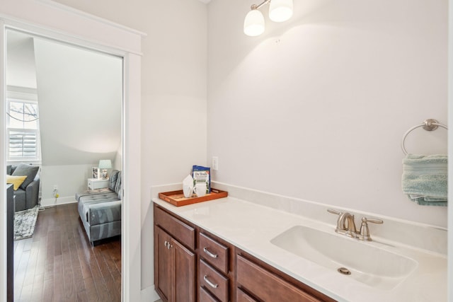 bathroom with wood-type flooring, baseboards, and a sink