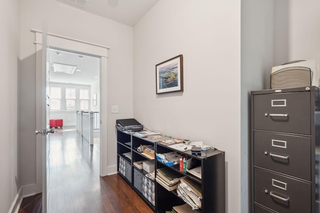 hall with dark wood-style floors and baseboards